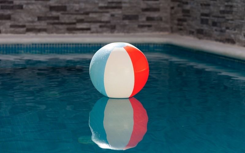 Photo of an inflatable ball floating on a pool that can deter birds and keep the from pooping on the porch.